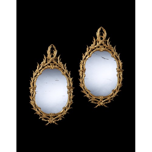 A PAIR OF GEORGE II OVAL GILTWOOD MIRRORS